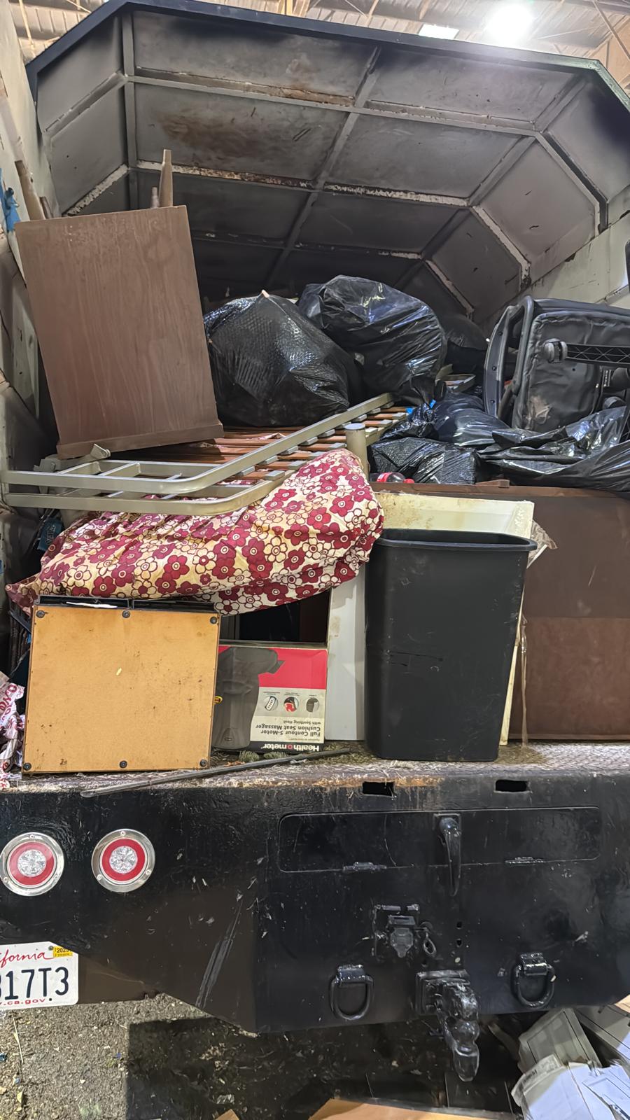 Mattress and bagged junk hauled in truck bed